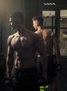 Fitness instructor. Man with torso, muscular macho and his reflexion in mirror background. Sport and gym concept