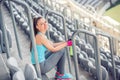 Fitness instructor resting and excercising. sportswoman enjoying a good, quality workout on stadium stairs Royalty Free Stock Photo