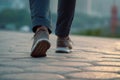 Fitness journey, Close-up of man\'s walking legs on outdoor walkway