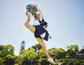 Fitness, jump and woman cheerleader on a field for motivation or support practice with team. Sports, cheerleading and Royalty Free Stock Photo