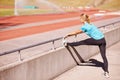 Fitness, legs and woman stretching in stadium for race, marathon or competition training for health. Sports, runner and Royalty Free Stock Photo