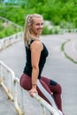 Fitness lifestyle. Young woman resting after exercise. Workout at the stadium. Healthy life concept