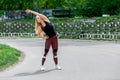 Fitness lifestyle. Young woman warming up before training doing exercises to stretch her muscles and joints. Sporty young blonde