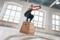 Strong man doing a box jump exercise at light hall Royalty Free Stock Photo