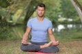 Fitness male doing yoga in park