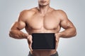 Fitness male holding horizontally digital tablet with blank scre