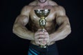 Fitness man being awarded with winning cup Royalty Free Stock Photo