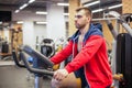 Fitness man on bicycle doing spinning at gym. Fit young man working out on gym bike. Royalty Free Stock Photo