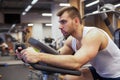 Fitness man on bicycle doing spinning at gym. Fit young man working out on gym bike. Royalty Free Stock Photo