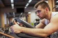 Fitness man on bicycle doing spinning at gym. Fit young man working out on gym bike. Royalty Free Stock Photo