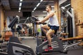 Fitness man on bicycle doing spinning at gym. Fit young man working out on gym bike. Royalty Free Stock Photo