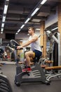 Fitness man on bicycle doing spinning at gym. Fit young man working out on gym bike. Royalty Free Stock Photo