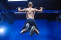 Fitness man doing pull-ups in a gym for a back workout back view Royalty Free Stock Photo