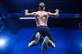 Fitness man doing pull-ups in a gym for a back workout back view Royalty Free Stock Photo