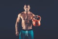 Fitness man doing a weight training by lifting heavy kettlebell Royalty Free Stock Photo