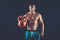 Fitness man doing a weight training by lifting heavy kettlebell Royalty Free Stock Photo