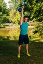 Crossfit fitness man training with kettlebell into the park Royalty Free Stock Photo