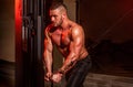 Fitness man execute exercise with exercise-machine Cable Crossover in gym. Handsome man with big muscles in gym. Machine Royalty Free Stock Photo