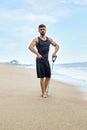 Fitness Man Exercising At Beach, Doing Expander Exercise Outdoor Royalty Free Stock Photo