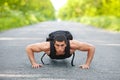 Fitness man exercising push ups, outdoor. Muscular male cross-training on city park