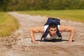 Fitness man exercising push ups, outdoor. Muscular male cross-training outside