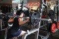 Fitness man in the gym doing squat . Man with dumbbell weight training equipment gym. Indoor, instructor. Royalty Free Stock Photo