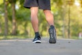 fitness man legs walking in the park outdoor, male runner running on the road outside, asian athlete jogging and exercise on footp Royalty Free Stock Photo