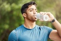 Fitness, man with in park, drinking water and hiking in nature for health and wellness during exercise. Drink, bottle