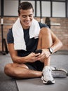 Fitness, man and phone with smile for social media, conversations or chatting while sitting on a mat at gym. Happy Royalty Free Stock Photo