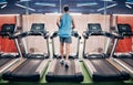 Fitness, man and running on treadmill at the gym for healthy cardio, exercise or weight loss workout. Active sports male Royalty Free Stock Photo