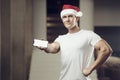 Fitness man in Santa Claus hat in gym