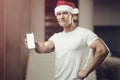 Fitness man in Santa Claus hat in gym