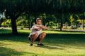 Fitness man training air squat exercise on green meadow Royalty Free Stock Photo