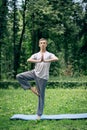 Fitness, man training yoga in tree pose in park Royalty Free Stock Photo