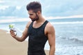 Fitness Man With Water Bottle Resting After Workout At Beach Royalty Free Stock Photo