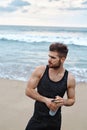 Fitness Man With Water Bottle Resting After Workout At Beach Royalty Free Stock Photo