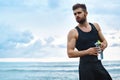 Fitness Man With Water Bottle Resting After Workout At Beach Royalty Free Stock Photo