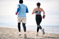 Fitness man and woman  running along beach Royalty Free Stock Photo