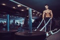 Fitness man working out with battle ropes at gym Royalty Free Stock Photo