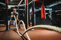 Fitness man working out with battle ropes at gym. Royalty Free Stock Photo