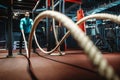 Fitness man working out with battle ropes at gym. Royalty Free Stock Photo