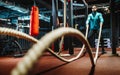 Fitness man working out with battle ropes at gym. Royalty Free Stock Photo