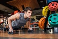 Fitness man working out and doing push-ups in gym Royalty Free Stock Photo