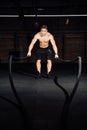 Fitness man workout with battle ropes at gym. training exercise fitted body in club. Torso. Royalty Free Stock Photo