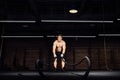Fitness man workout with battle ropes at gym. training exercise fitted body in club. Torso. Royalty Free Stock Photo