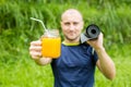 Fitness man with yoga mat holding a glass of orange juice Royalty Free Stock Photo