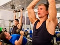 Fitness men friends in gym workout weights with equipment. Royalty Free Stock Photo