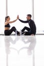 Fitness man and woman giving each other a high five after the training session in gym. Fit couple high five after workout in Royalty Free Stock Photo