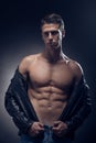 Fitness model posing, muscular abs chest, upper body shot, one y