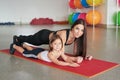Fitness mother and child. Sports activities with children. Fitness center. Mom and baby gymnastics, yoga exercises. Health and Royalty Free Stock Photo